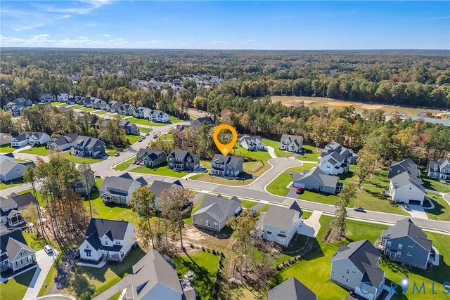 an aerial view of residential houses with outdoor space