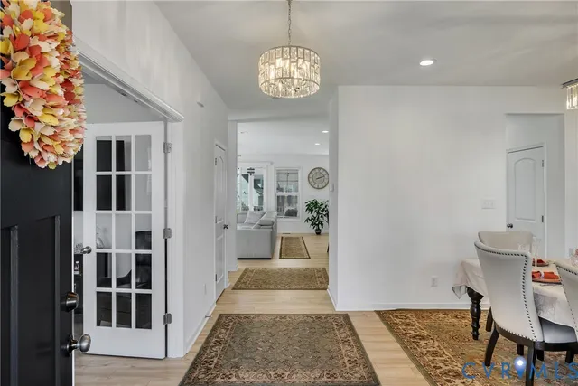 a hallway with a dining table and chairs