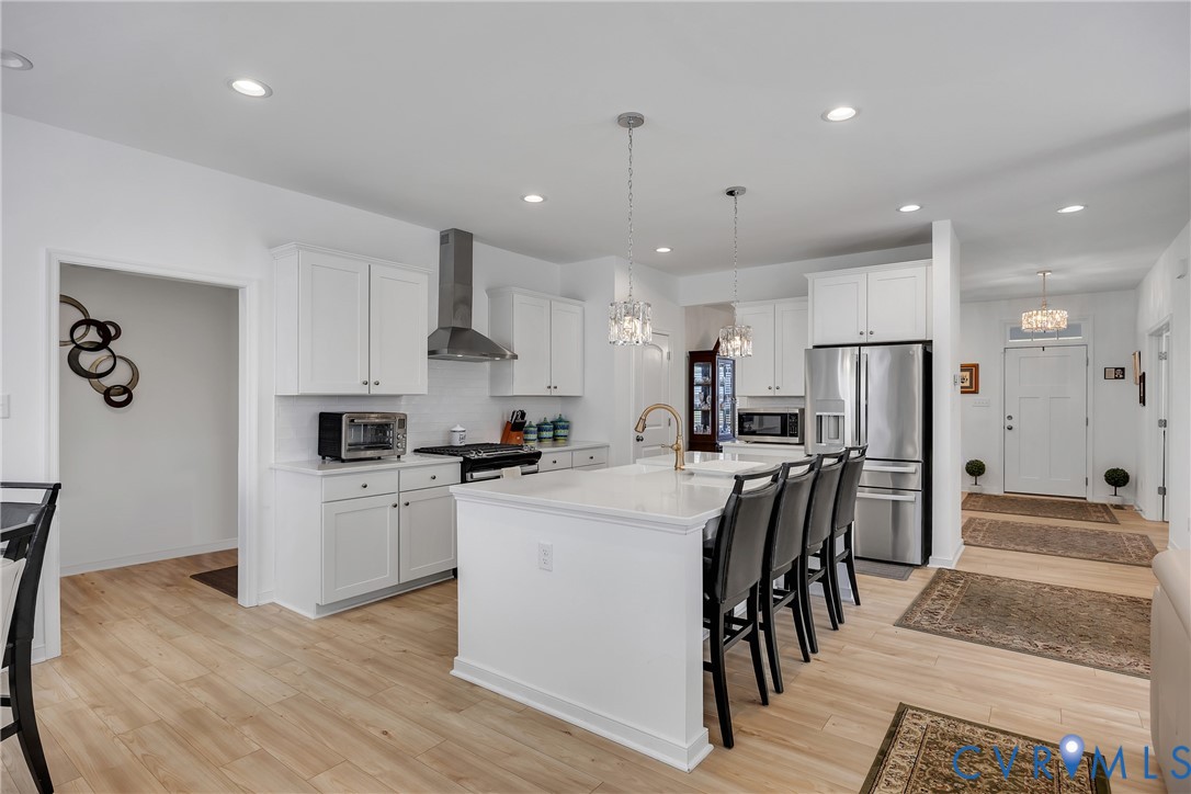 9400 Kinnerton Drive Midlothian, VA 23112 - Photo 9 of 43 a kitchen with white cabinets and stainless steel appliances
