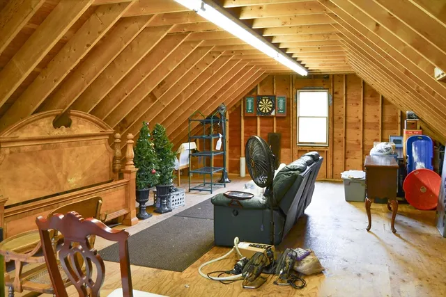 a view of an chairs and table on the roof deck