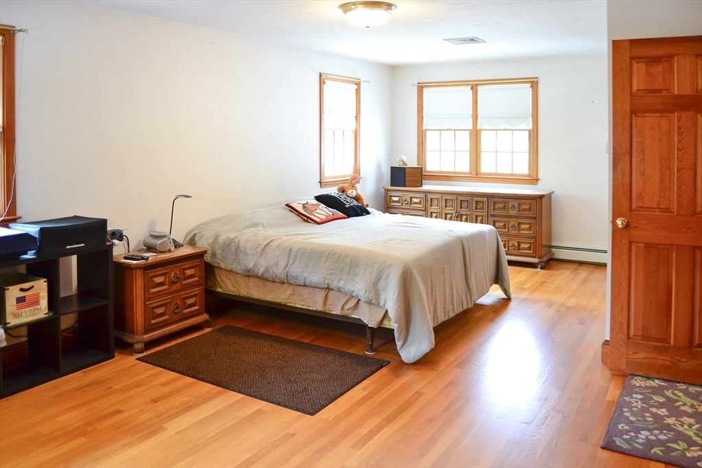 110 Mayflower Ridge Drive Wareham, MA 02571 - Photo 17 of 42 a bedroom with a bed and wooden floor