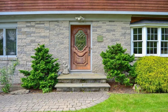 a front view of a house with garden