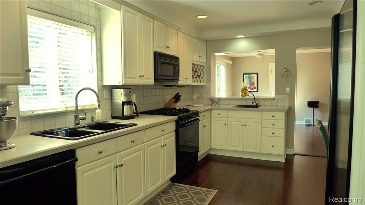 1806 Prestwick Road Grosse Pointe, MI 48236 - Photo 2 of 18 Updated kitchen with custom white cabinetry,new hardwood floors, breakfast bar & built-in wine rack.