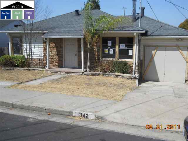 1342 Mahoney Street Rodeo, CA 94572 - Photo 1 of 1 front view of a brick house with a bench