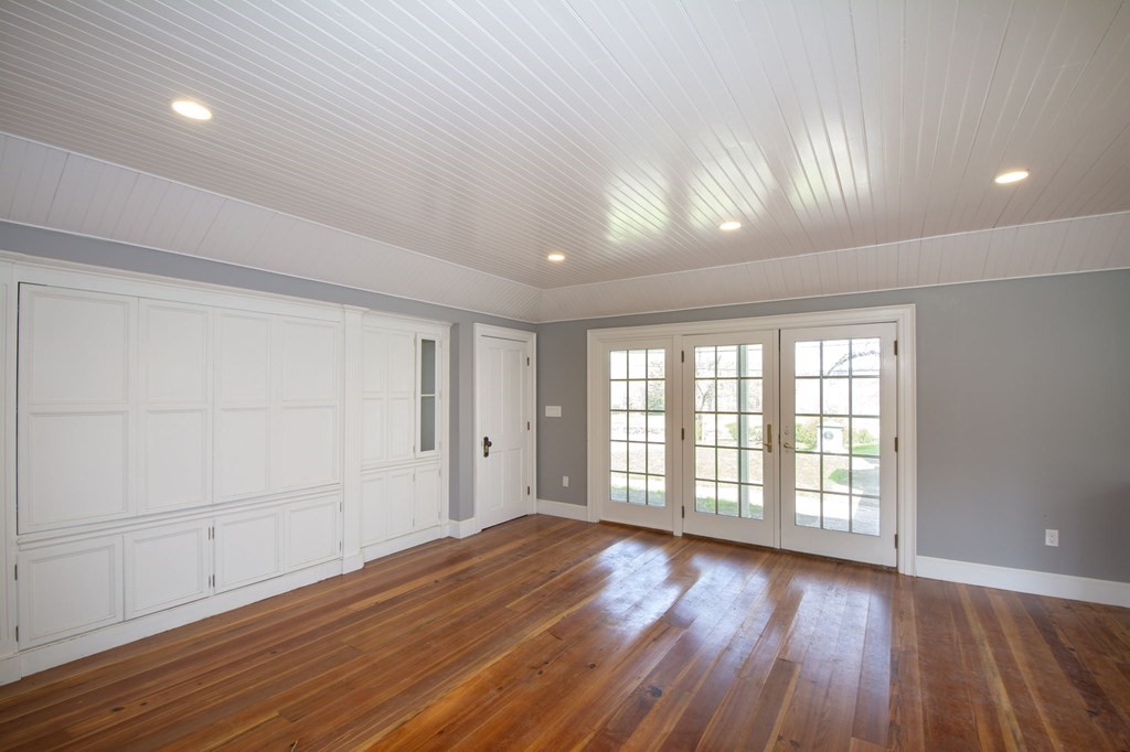 128 Washington Street, Unit F Hanover, MA 02339 - Photo 12 of 42 a view of an empty room with wooden floor and a window