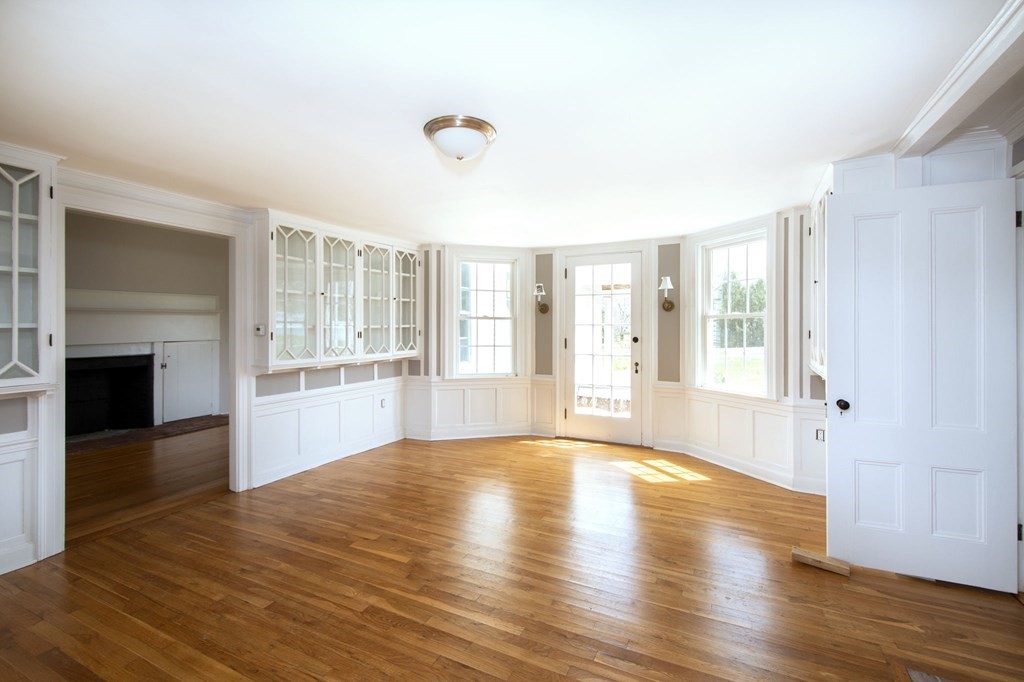 128 Washington Street, Unit F Hanover, MA 02339 - Photo 17 of 42 a view of an empty room with wooden floor and a window