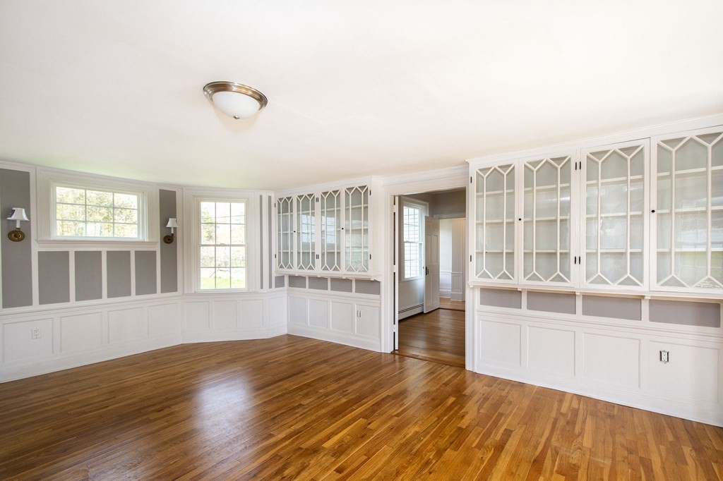 128 Washington Street, Unit F Hanover, MA 02339 - Photo 18 of 42 a view of an empty room with wooden floor and a window