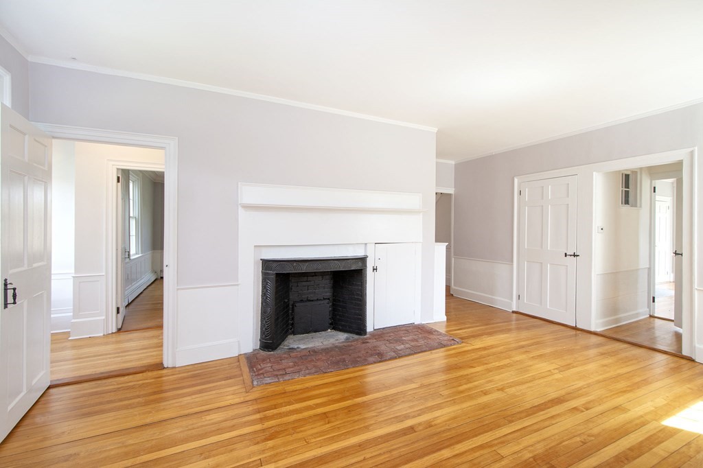 128 Washington Street, Unit F Hanover, MA 02339 - Photo 19 of 42 a view of empty room with wooden floor and fireplace