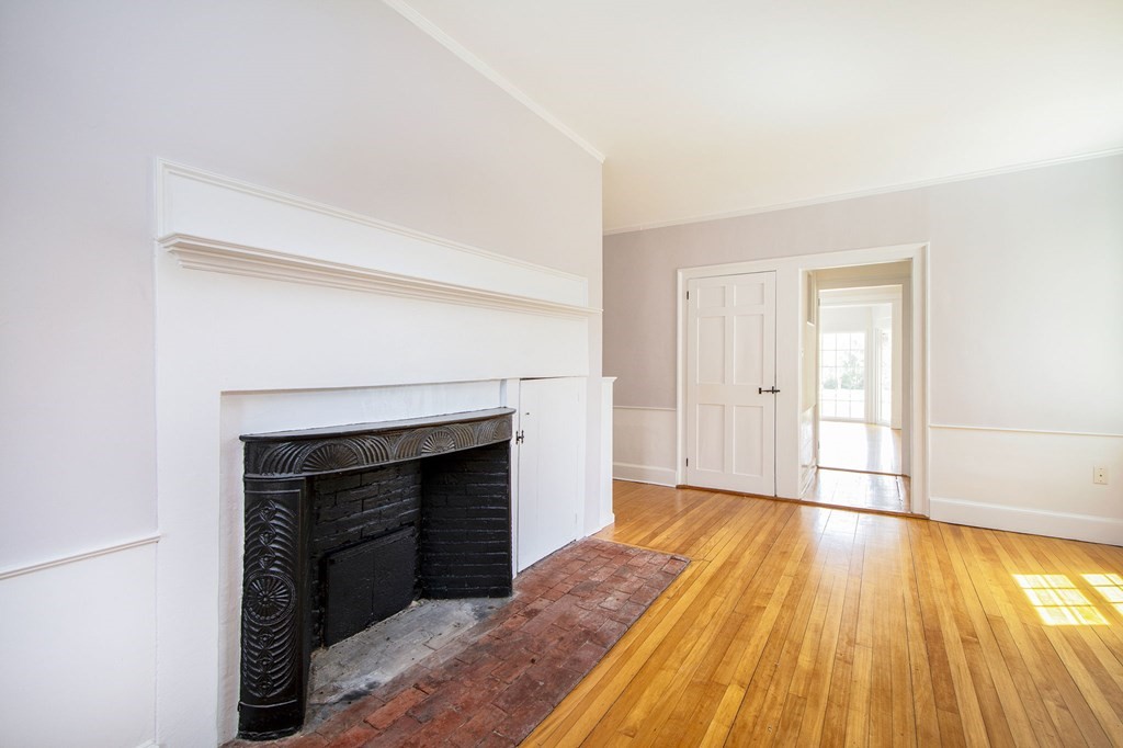 128 Washington Street, Unit F Hanover, MA 02339 - Photo 20 of 42 a view of empty room with wooden floor and fireplace
