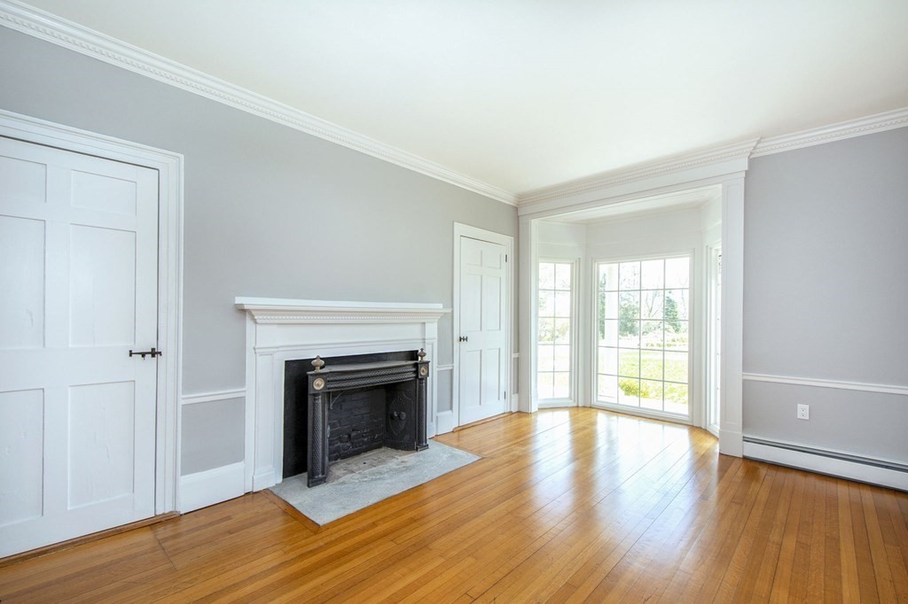 128 Washington Street, Unit F Hanover, MA 02339 - Photo 21 of 42 wooden floor fireplace and natural light in room