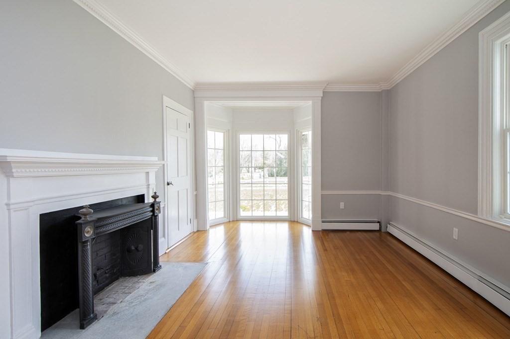 128 Washington Street, Unit F Hanover, MA 02339 - Photo 22 of 42 wooden floor fireplace and natural light in room