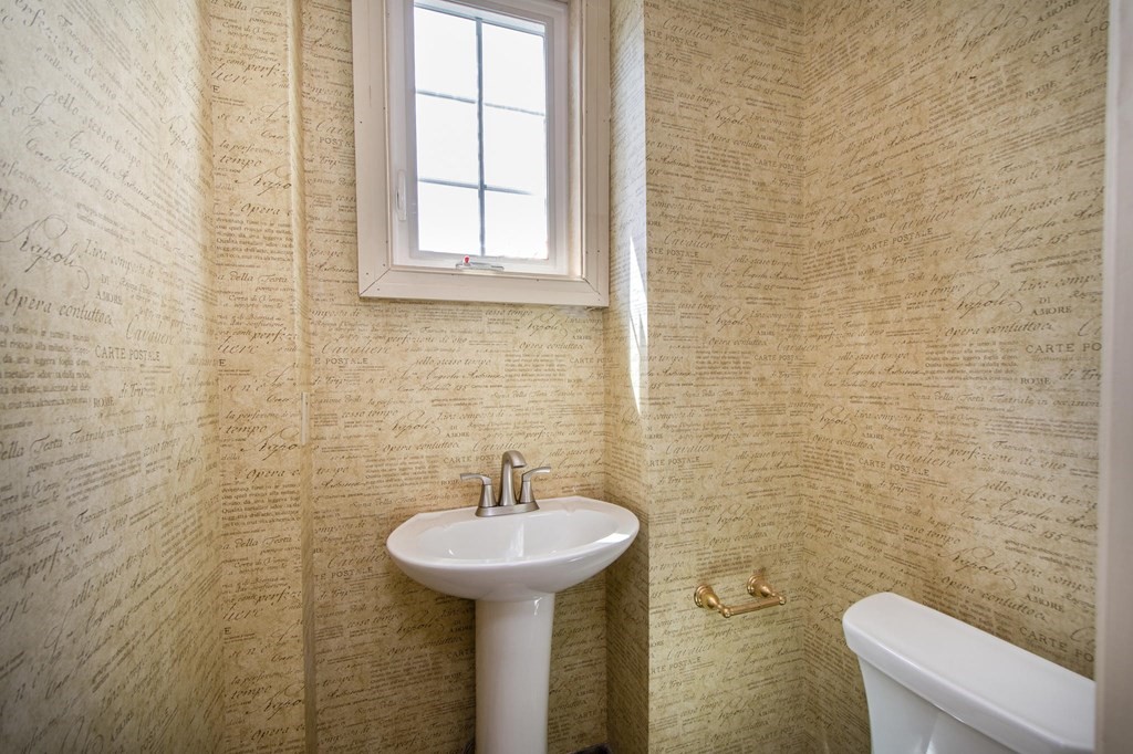 128 Washington Street, Unit F Hanover, MA 02339 - Photo 23 of 42 a bathroom with a sink a toilet and mirror