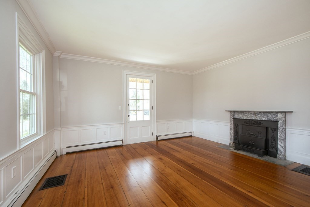 128 Washington Street, Unit F Hanover, MA 02339 - Photo 25 of 42 an empty room with wooden floor fireplace and windows