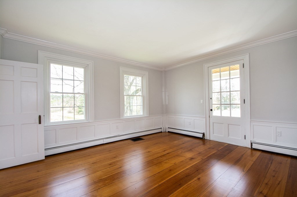 128 Washington Street, Unit F Hanover, MA 02339 - Photo 26 of 42 an empty room with wooden floor and windows