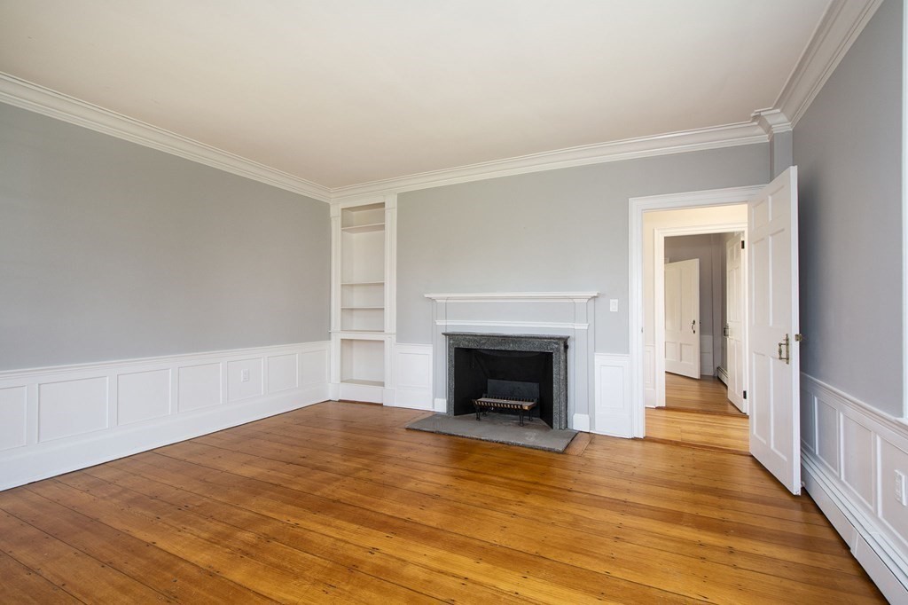 128 Washington Street, Unit F Hanover, MA 02339 - Photo 27 of 42 a view of empty room with wooden floor and fireplace