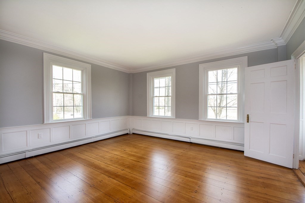 128 Washington Street, Unit F Hanover, MA 02339 - Photo 28 of 42 an empty room with wooden floor and windows