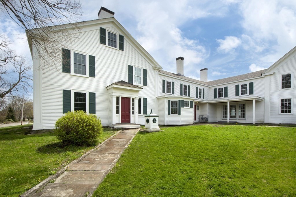 128 Washington Street, Unit F Hanover, MA 02339 - Photo 3 of 42 a front view of a house with a yard