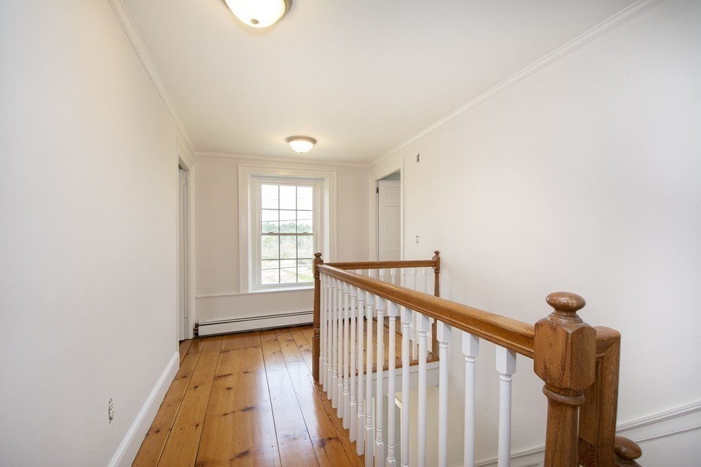 128 Washington Street, Unit F Hanover, MA 02339 - Photo 32 of 42 a view of a hallway with wooden floor and stairs