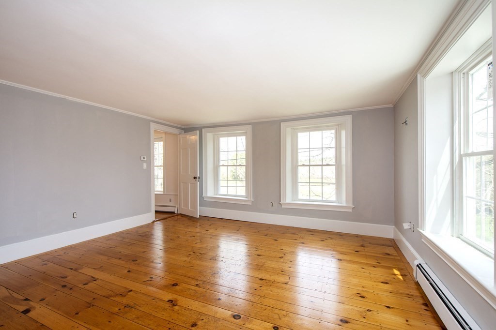 128 Washington Street, Unit F Hanover, MA 02339 - Photo 33 of 42 an empty room with wooden floor and windows