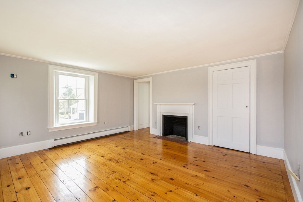 128 Washington Street, Unit F Hanover, MA 02339 - Photo 34 of 42 a view of empty room with wooden floor and fireplace
