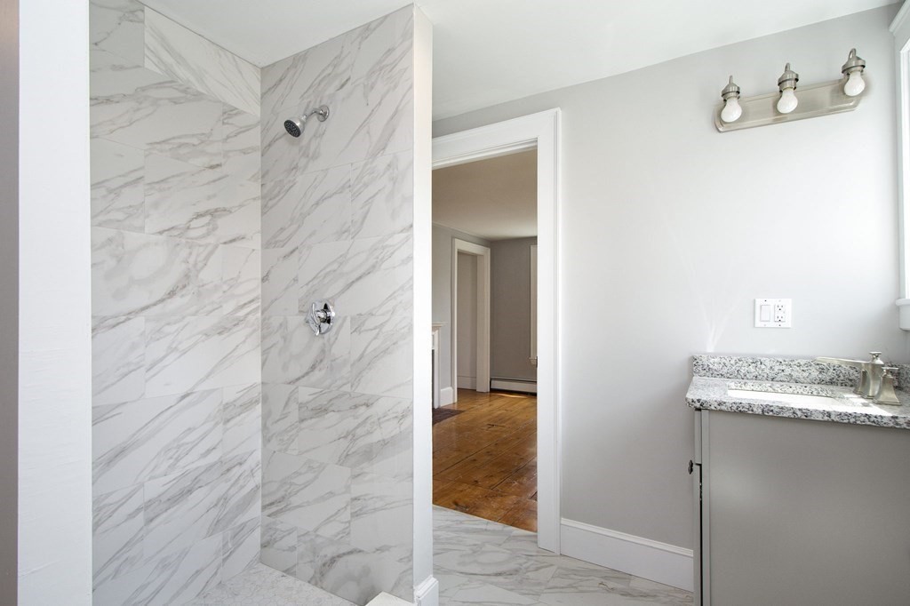 128 Washington Street, Unit F Hanover, MA 02339 - Photo 36 of 42 a bathroom with a granite countertop shower and a sink