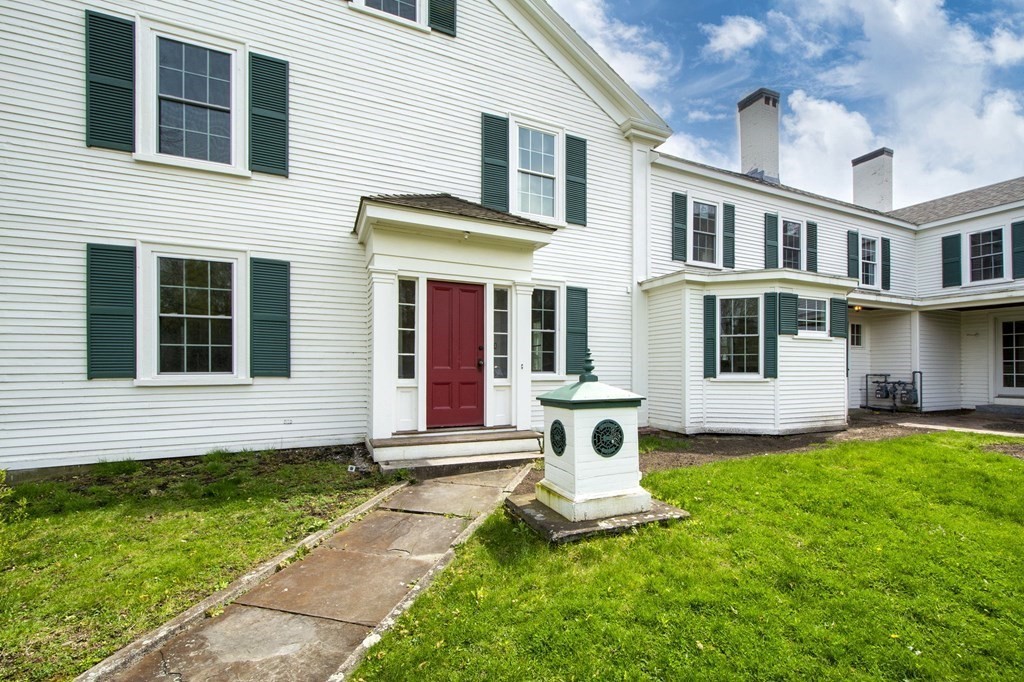 128 Washington Street, Unit F Hanover, MA 02339 - Photo 4 of 42 a front view of a house with a yard and porch