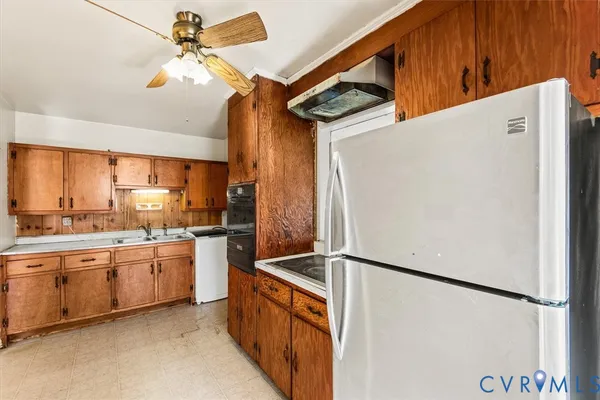 a kitchen with stainless steel appliances a refrigerator and a sink