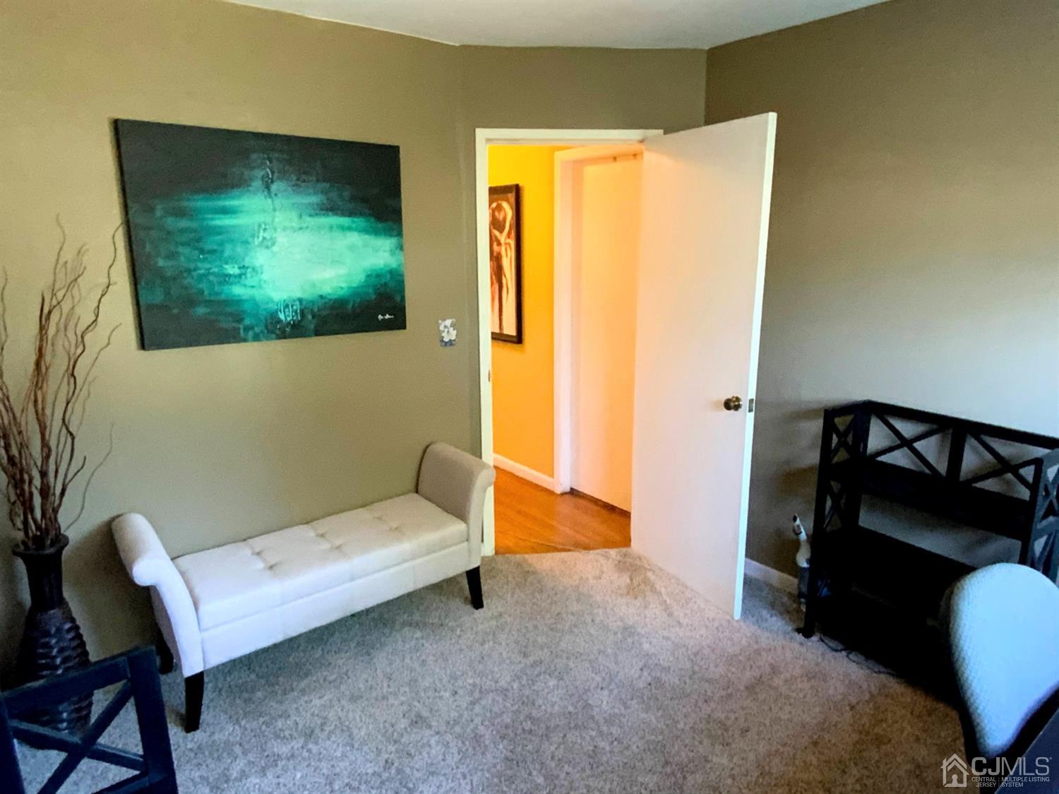 56 Farmingdale Road Fords, NJ 08863 - Photo 13 of 18 a bedroom with a bed and a chair