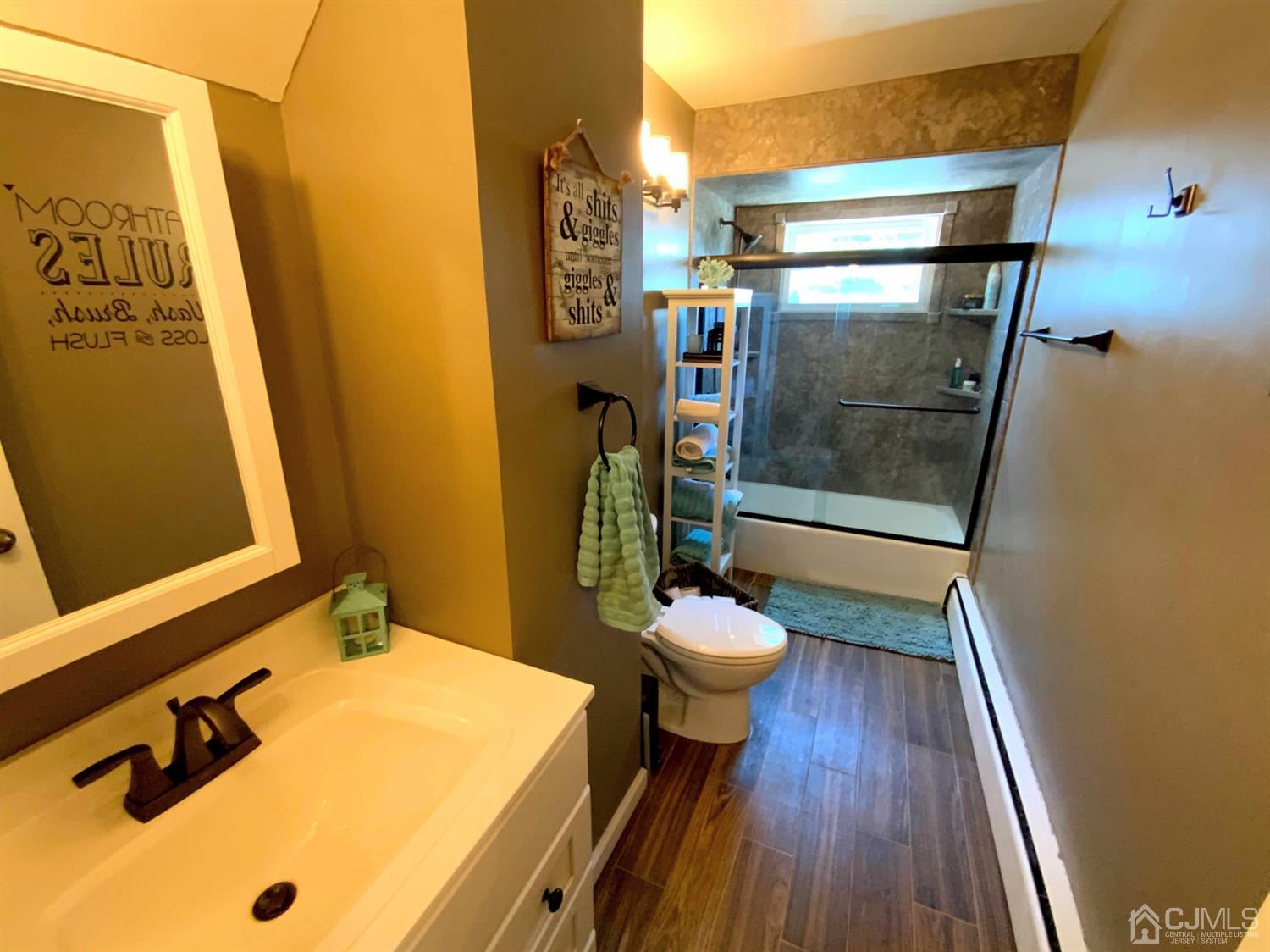 56 Farmingdale Road Fords, NJ 08863 - Photo 16 of 18 a bathroom with a sink and a mirror