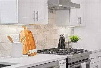 a kitchen with a stove and cabinets
