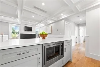 a kitchen with stainless steel appliances kitchen island granite countertop a sink a stove and cabinets