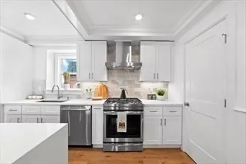 a kitchen with stainless steel appliances granite countertop a stove and a sink