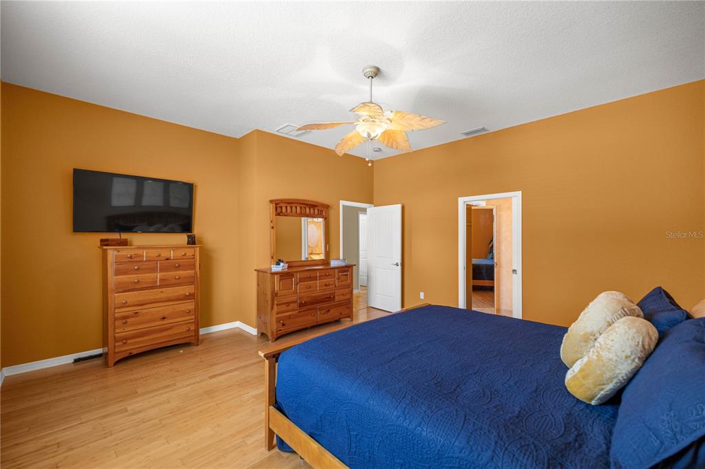 3817 North Calusa Point Crystal River, FL 34428 - Photo 15 of 54 a bedroom with a bed and wooden floor