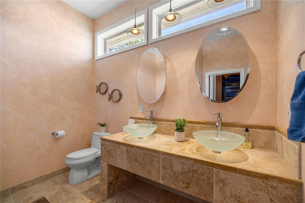 3817 North Calusa Point Crystal River, FL 34428 - Photo 16 of 54 a bathroom with a granite countertop toilet sink and mirror