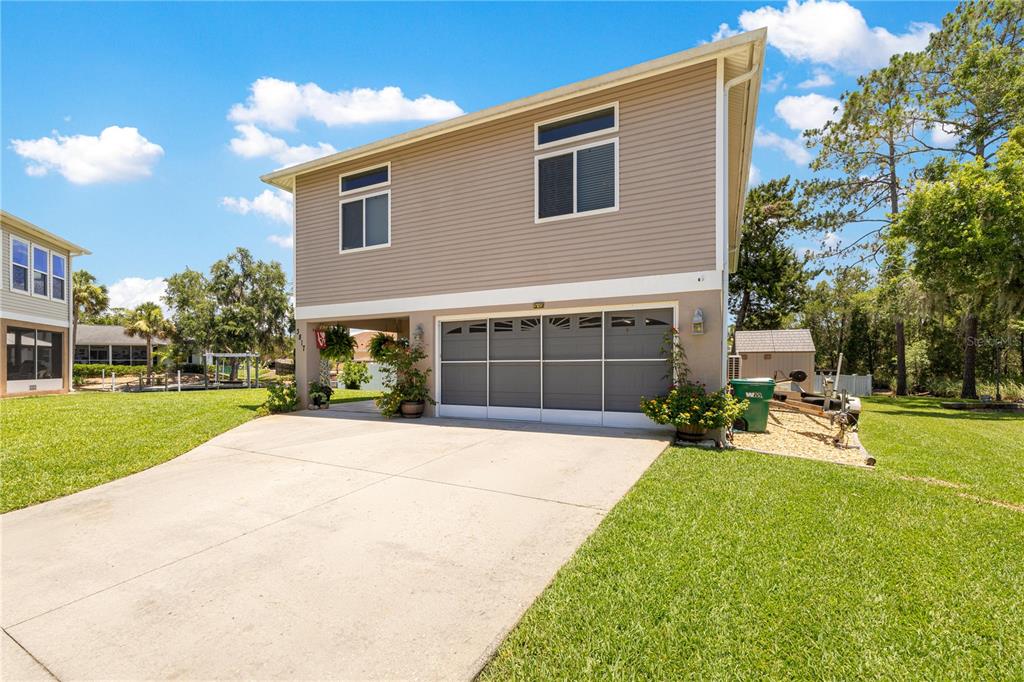 3817 North Calusa Point Crystal River, FL 34428 - Photo 2 of 54 a front view of a house with a yard and garage