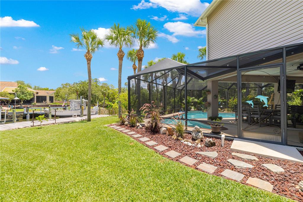 3817 North Calusa Point Crystal River, FL 34428 - Photo 37 of 54 a view of a patio with a table and chairs under an umbrella