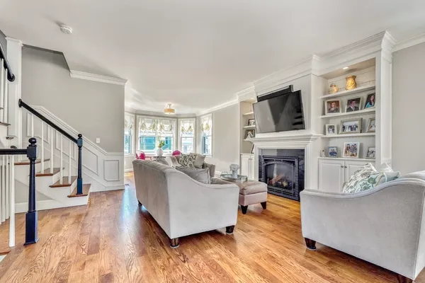 a living room with furniture a fireplace and a flat screen tv