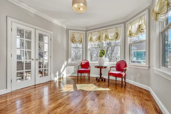 a dining room with wooden floor and furniture
