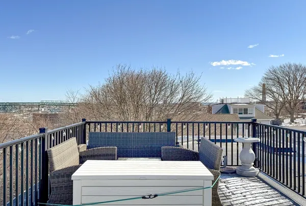 a view of a roof deck with wooden floor and fence