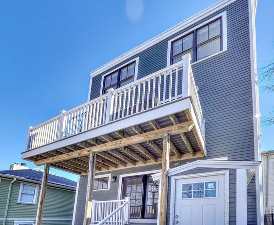 a view of a house with wooden deck