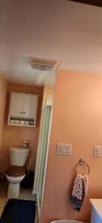 a bathroom with a toilet and a shower