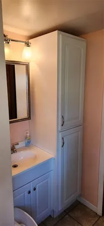 a bathroom with a mirror and a sink