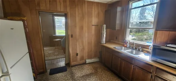 a kitchen with granite countertop a refrigerator and a sink