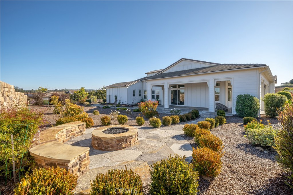 1541 Mesa Road Nipomo, CA 93444 - Photo 26 of 70 a view of a patio with couches table and chairs under an umbrella next to a road
