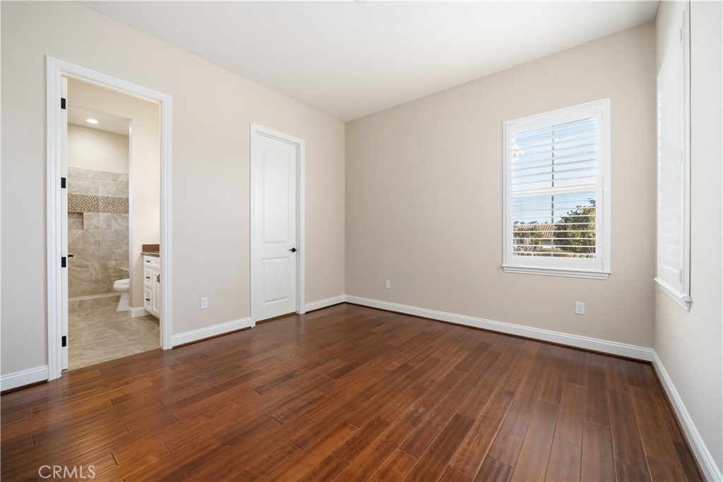 1541 Mesa Road Nipomo, CA 93444 - Photo 49 of 70 an empty room with wooden floor and windows