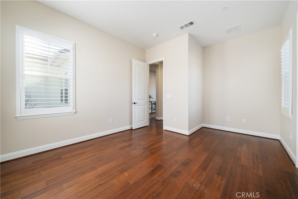 1541 Mesa Road Nipomo, CA 93444 - Photo 50 of 70 an empty room with wooden floor and windows