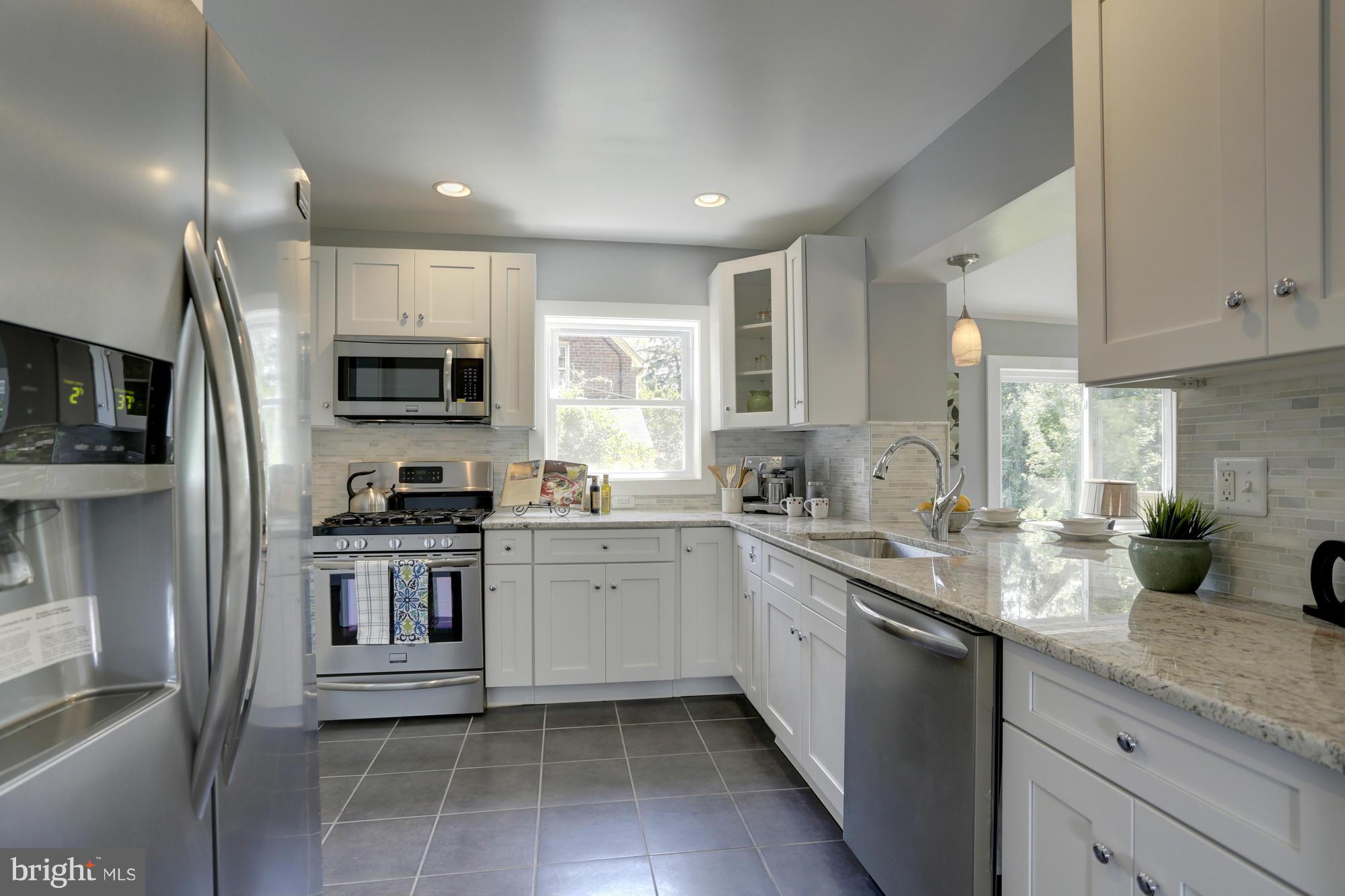9508 Colesville Road Silver Spring, MD 20901 - Photo 8 of 27 a kitchen with a sink a counter space appliances and cabinets