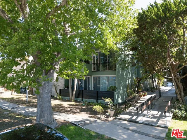 a view of a tree in front of a yard