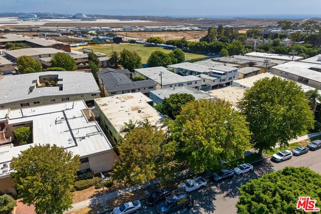 an aerial view of multiple houses with yard