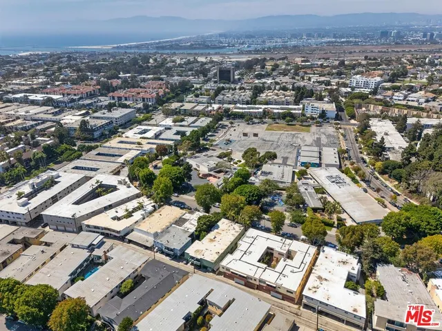 an aerial view of residential houses with city view